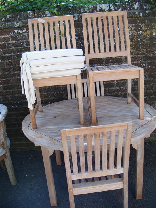 Teak extending garden table and a set of four chairs (with pad cushions)